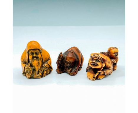 Three intricately and delicately carved figurines depicting different deities or legends. These pieces do not have a fully fu