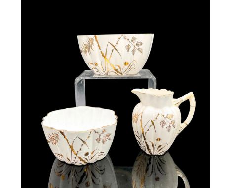 White porcelain with gold foliage design, accents and rims. Pitcher 4"L x 2.75"W x 4"H. Larger bowl 3"H x 5.75"dia. Smaller b