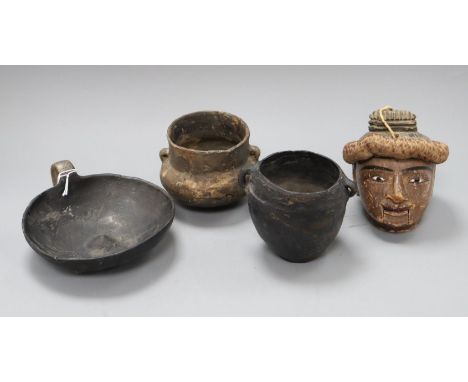 A Burmese wooden puppet head and three pottery vessels
