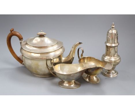 A pair of Edwardian silver sauce boats, a silver sugar caster and a silver teapot, gross 36 oz.