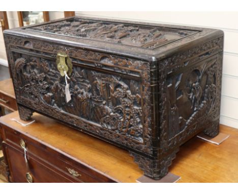 A Chinese carved camphorwood trunk W.90cm