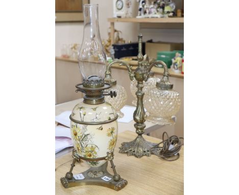 A Victorian brass and ceramic oil lamp and a cast gilt metal three light table lamp