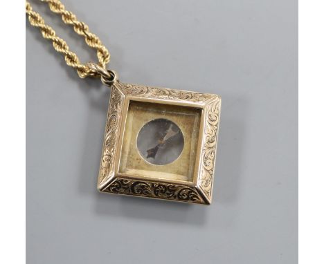 A late Victorian engraved 9ct gold mounted compass pendant, on a later 9k ropetwist chain, compass 27mm.