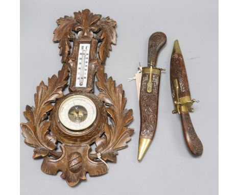 A wood and brass-mounted 'dagger' two-piece carving set and a wall barometer/thermometer in carved wood surround