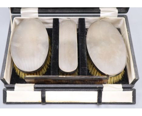 An early 1960's cased engine turned silver mounted four piece brush and comb set.