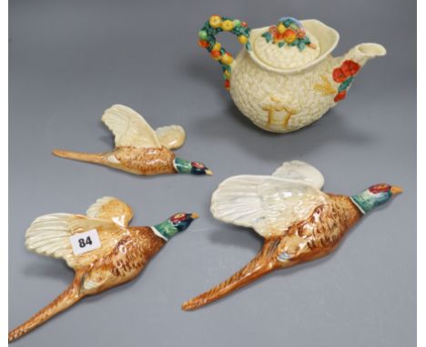 A Clarice Cliff harvest pattern teapot and three Beswick flying pheasants