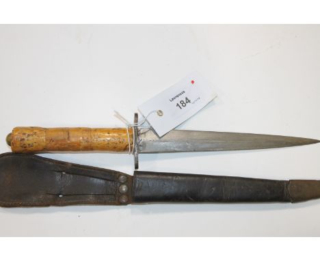 A FIGHTING KNIFE. A Fighting Knife and scabbard in the Commando Dagger (F-S) style, with a cork grip in three sections.