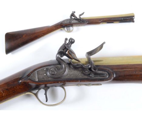 A FLINTLOCK BLUNDERBUSS BY WILLIAMS. A brass barrelled Flintlock Blunderbuss by Williams of London. A B Wilson is listed as m