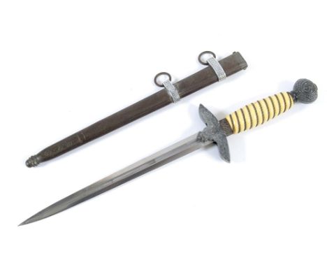 A LUFTWAFFE DAGGER. A second pattern Luftwaffe officers dagger, complete with its scabbard. White grips with wire intact, pla