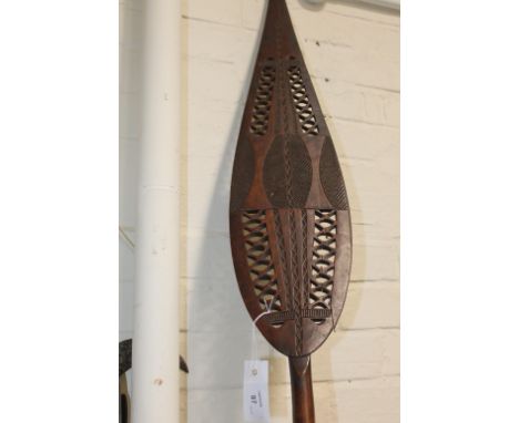 A CARVED NATIVE PADDLE. A carved and well made 20thC period Native Paddle, with pierced blade and shaft. Some light damage ev
