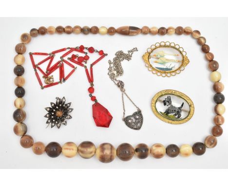 SIX ITEMS OF JEWELLERY, to include a carved horn bead necklace with screw clasp, a red bead necklace, a white metal marcasite