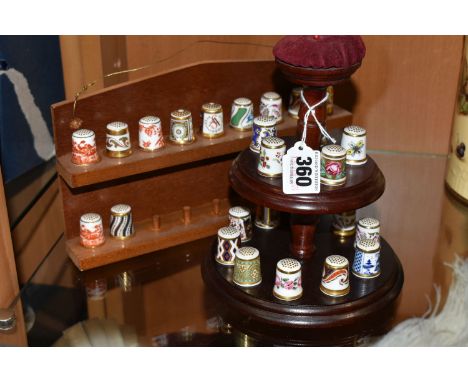 A COLLECTION OF ROYAL CROWN DERBY PORCELAIN THIMBLES, comprising fifteen Royal Crown Derby thimbles on a thimble stand with p