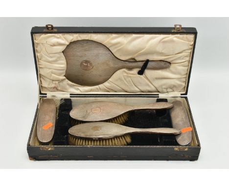 A CASED SILVER VANITY SET, to include four brushes and a mirror (comb is missing), engine turned pattern detail and vacant ca