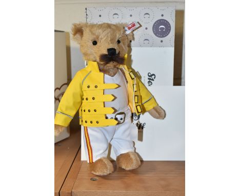 A BOXED STEIFF LIMITED EDITION FREDDIE MERCURY TEDDY BEAR, with certificate numbered 908/5000, in golden mohair with brown mo