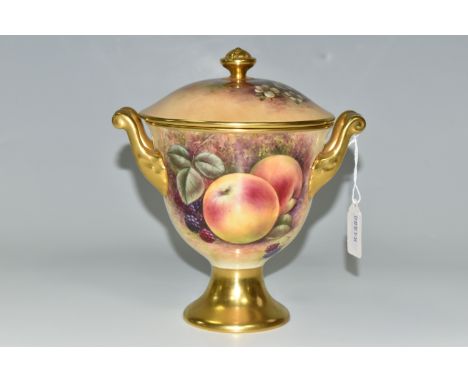 A COALPORT COVERED VASE, the gilt footed vase with twin gilt handles, hand painted with apples, blackberries and blossom by R