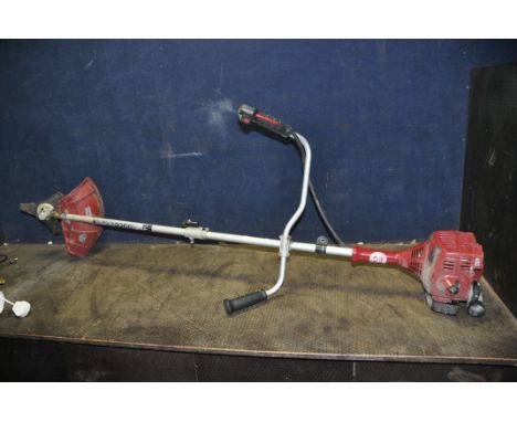 AN EINHELL GC BC 25 AS PETROL STRIMMER with brush cutting head fitted (engine pulls freely but hasn't started)