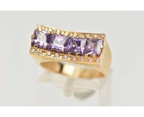 A YELLOW METAL DRESS RING, a rectangular form mount with concave detail, set with four purple square cut cubic zirconia, also