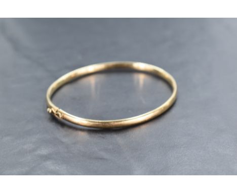 A 9ct gold bangle of plain form having concealed clasp, approx 5g