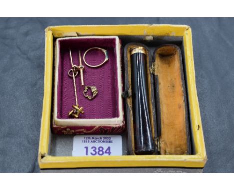 A small selection of gold and yellow metal including a malachite set ring stamped 14K, a cased cigarette holder with collar s