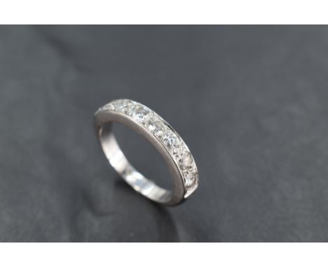 An 18ct white gold half eternity ring, having a linear arrangement of seven diamond brilliants totalling 1.05 ts approx, the 