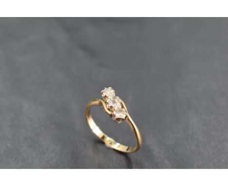 A diamond trilogy ring, total approx 0.35ct having crossover shoulders on a yellow metal loop, marks worn, size R &amp; appro