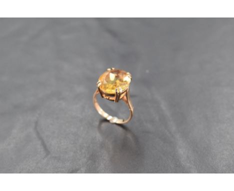 A 9ct gold and citrine dress ring, the oval-cut stone claw set to the plain shank, marked 375, ring size K-L, 4grams