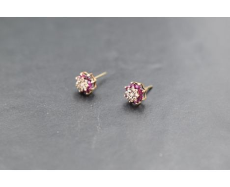 A pair of ruby &amp; diamond chip cluster stud earrings in 9ct gold mounts