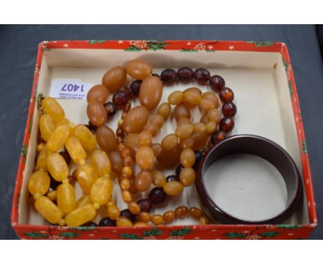 Four amber style necklaces and a bangle