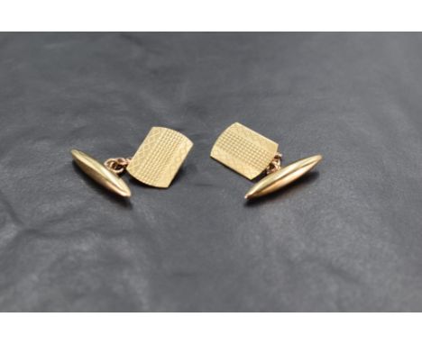 A pair of 9ct gold cufflinks having engine turned panels with chain connecters and lozenge shaped backs, approx 4g