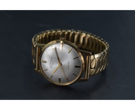 A gents yellow metal cased Rotary wristwatch, thought to be gold, the champagne dial with baton markers, all between an expan