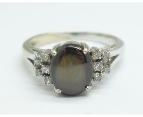 An 18ct white gold, cats eye stone and diamond ring, 5.4g, U 