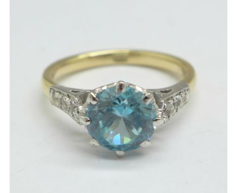 A 9ct gold and zircon solitaire ring with diamond shoulders, 2.9g, L 