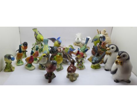 A collection of twenty bird figures including Beswick and a novelty penguin salt and pepper pair, (13 a/f) 