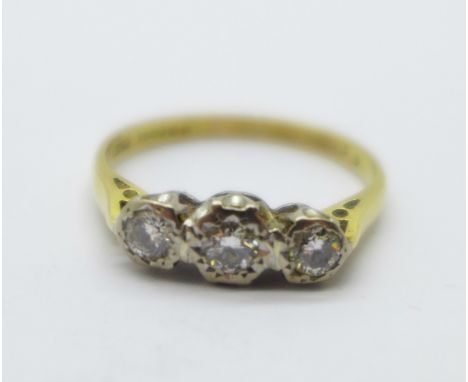 An 18ct gold, three stone diamond ring, 3.2g, R 