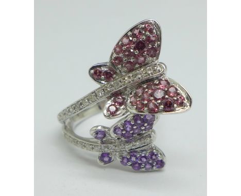 A 9ct white gold butterfly design cocktail ring set with 25 diamonds, 26 rubies and 16 amethysts, 5.8g, O 