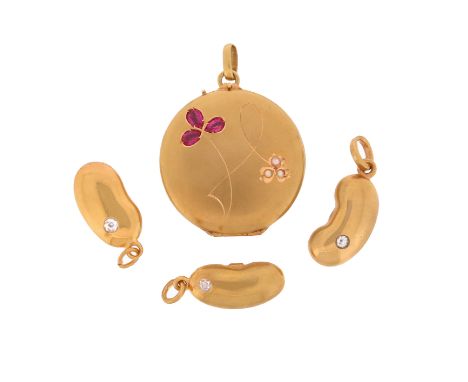 A French gold circular locket pendant, the cover mounted with a ruby and a seed pearl trefoil, 2.5cm wide, and three gold pen