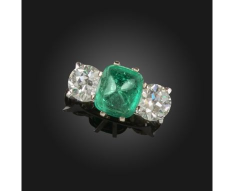 An emerald and diamond three-stone ring, the sugarloaf cabochon emerald is set with an old circular-cut diamond to each shoul