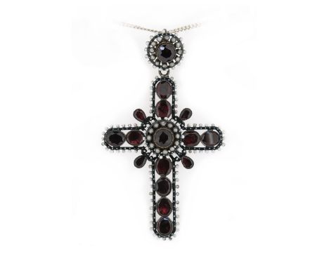 A garnet-set cruciform pendant, set with oval and pear-shaped garnets in closed-back settings, with black and white enamel de