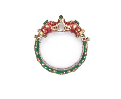An Indian gold bangle, the terminals designed as serpent's heads, decorated overall with Jaipur enamel and set with diamonds 