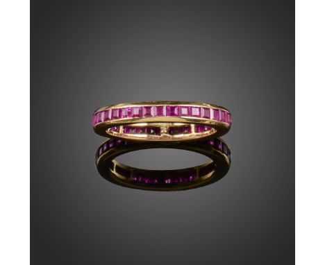 A ruby full circle eternity ring, the calibre-cut rubies are channel-set in gold, size R