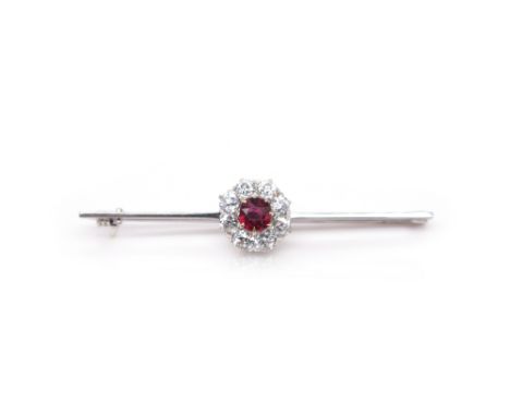 A ruby and diamond cluster bar brooch, centred with a cushion-shaped ruby within a surround of old circular-cut diamonds on a