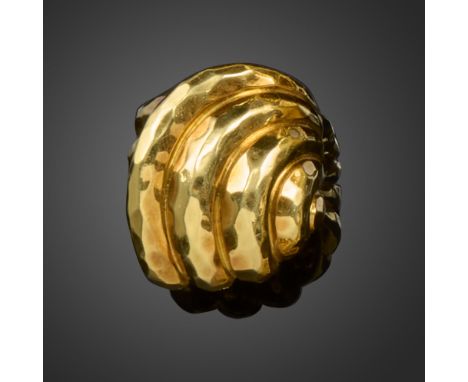 A gold cocktail ring by Henry Dunay, of bombe form with faceted hammered finish in gold, signed Dunay, stamped 18k size K app