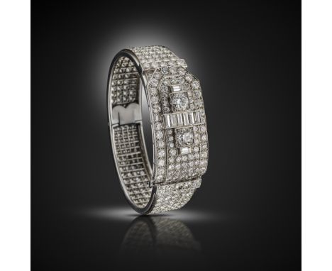 An impressive French diamond strap bangle, c.1930's, the hinged bangle is pav‚-set overall with circular-cut diamonds with tw