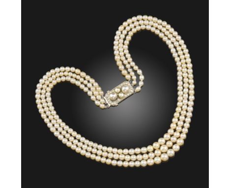 A three-row natural pearl necklace, the pearls graduate from 3.4 - 6.2mm, with a pearl and diamond-set platinum plaque clap, 