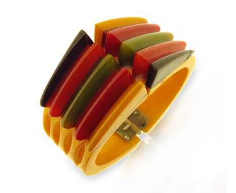 An Art Deco 'PHILADELPHIA' Bakelite bangle, the tapered bangle with vari-coloured bakelite sections, 6.2cm diameter