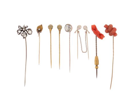 λ Eight 19th century stick pins, including a pair of Archaeological Revival gold stick pins with white enamel decoration; a p