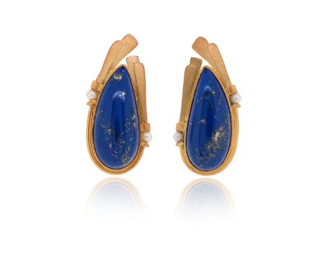 A pair of lapis lazuli gold ear clips by Erte, each of assymetrical design, the textured gold reeded surmount with cultured p