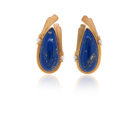 A pair of lapis lazuli gold ear clips by Erte, each of assymetrical design, the textured gold reeded surmount with cultured p