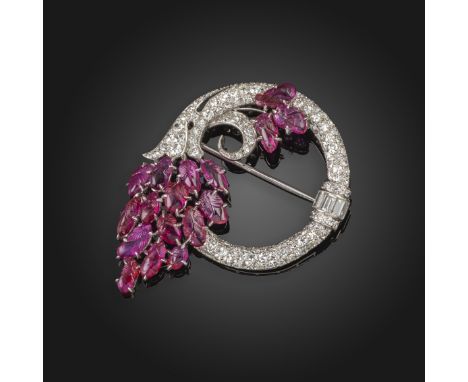 A carved ruby and diamond circular brooch, c.1930's, the stylised cornucopia brooch pav‚-set overall with round brilliant-cut