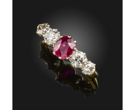 A ruby and diamond five-stone ring, the cushion-shaped ruby set with old circular-cut diamonds to each shoulder in two-colour